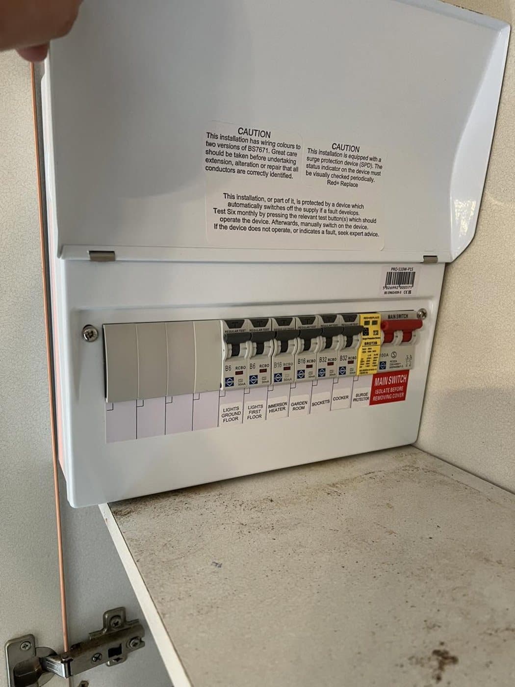 Open consumer unit neatly wired with individual RCBOs and surge protection