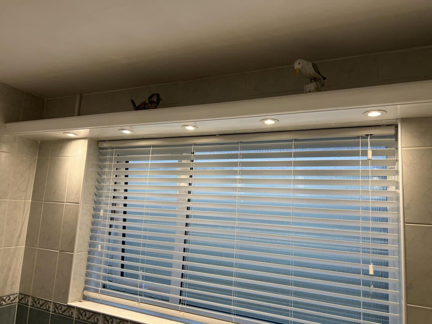 Recessed downlights fitted above a window with fitted blinds