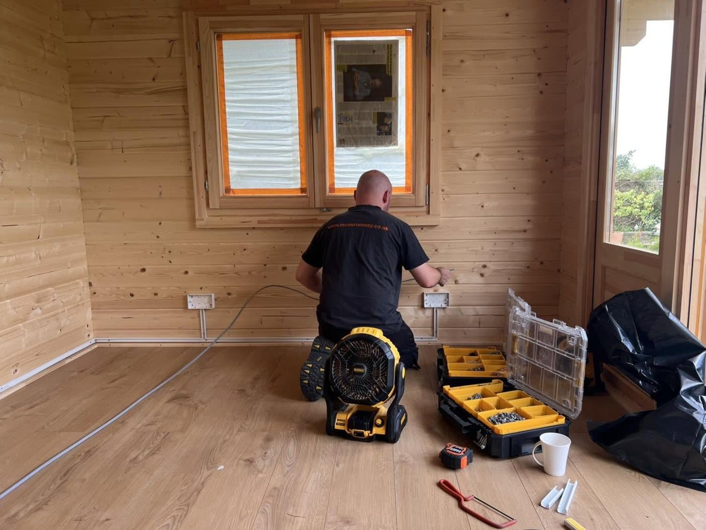 First-fix wiring and sockets run through a timber garden room before lining