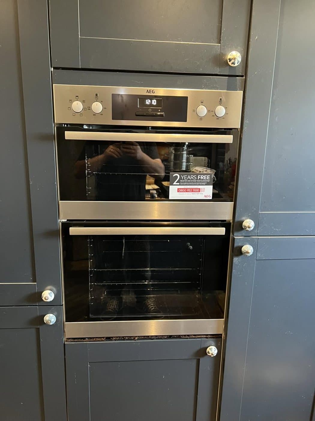 Built-in double oven wired and fitted in a grey shaker kitchen
