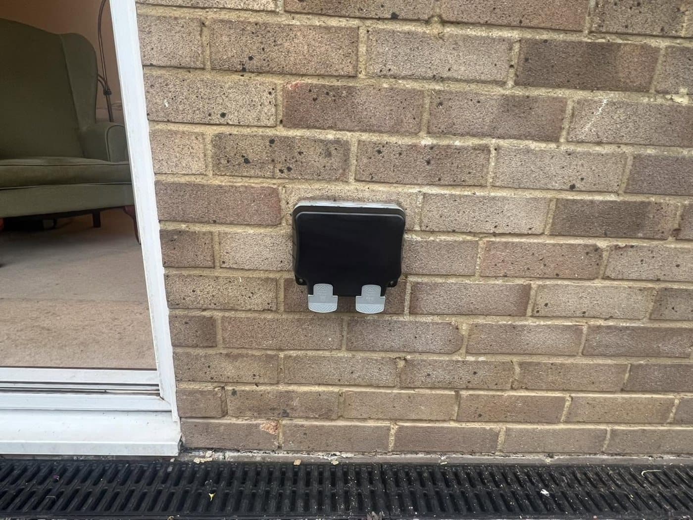 Exterior security light and weatherproof junction box fitted to brickwork